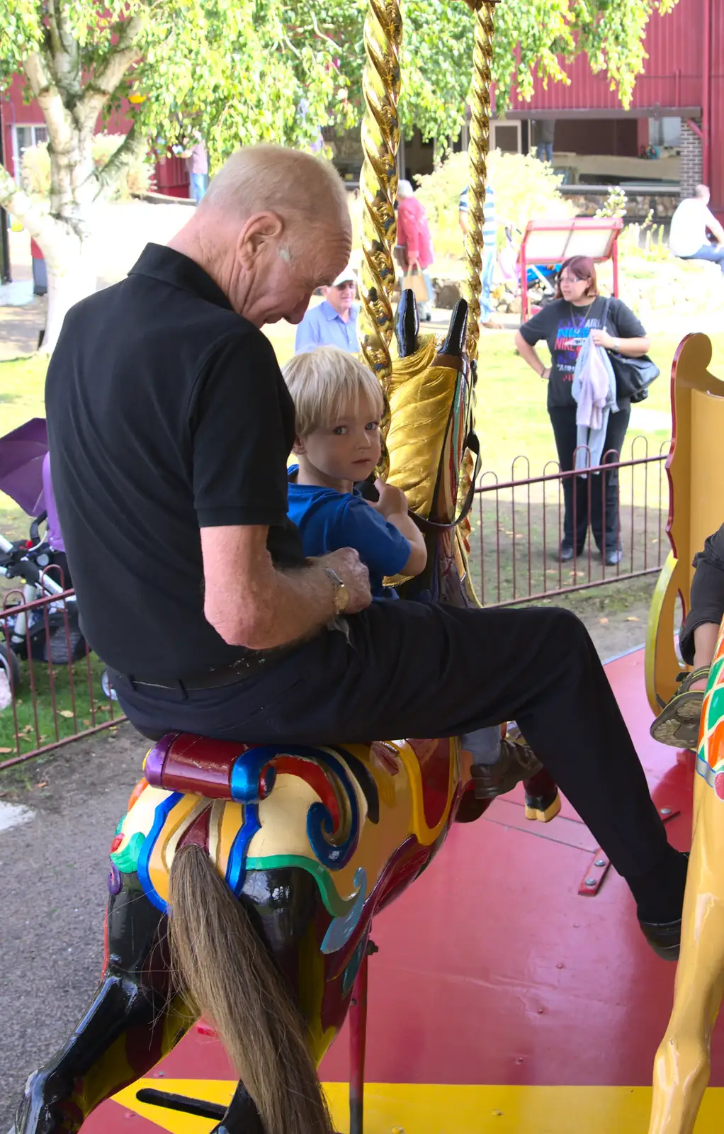 Grandad takes Harry on the gallopers, from A Trip to Bressingham Steam Museum, Bressingham, Norfolk - 28th September 2014