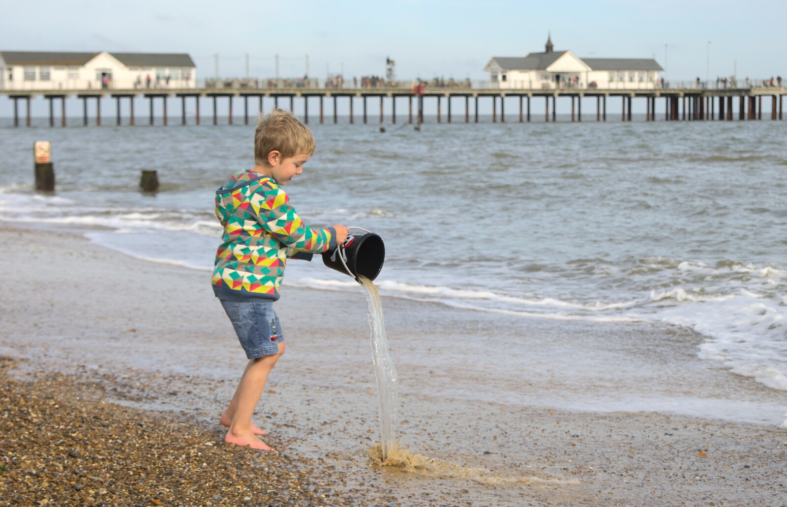 Fred tips some water back in to the sea from On The Beach Again, Southwold, Suffolk - 12th October 2014