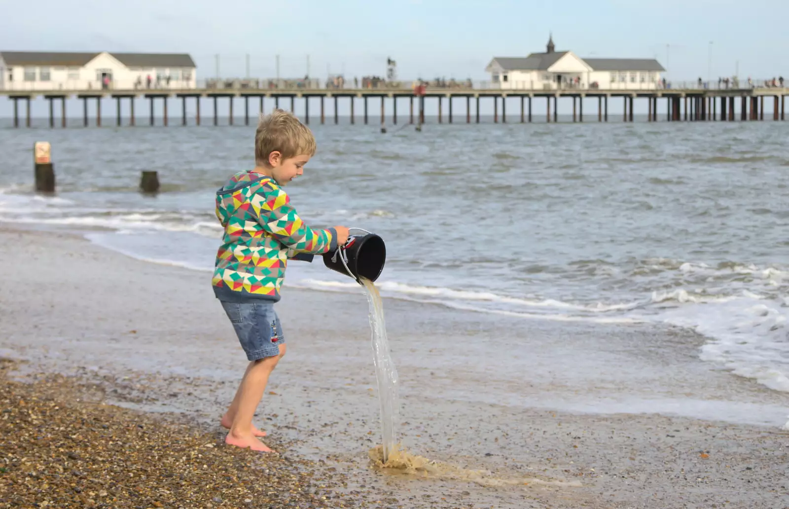 Fred tips some water back in to the sea, from On The Beach Again, Southwold, Suffolk - 12th October 2014