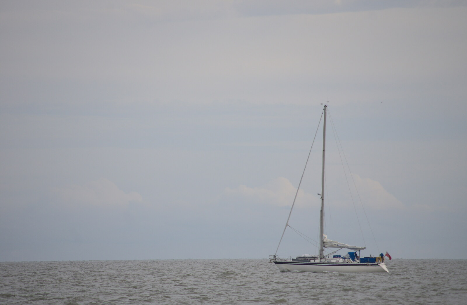 A yacht motors up the coast from On The Beach Again, Southwold, Suffolk - 12th October 2014