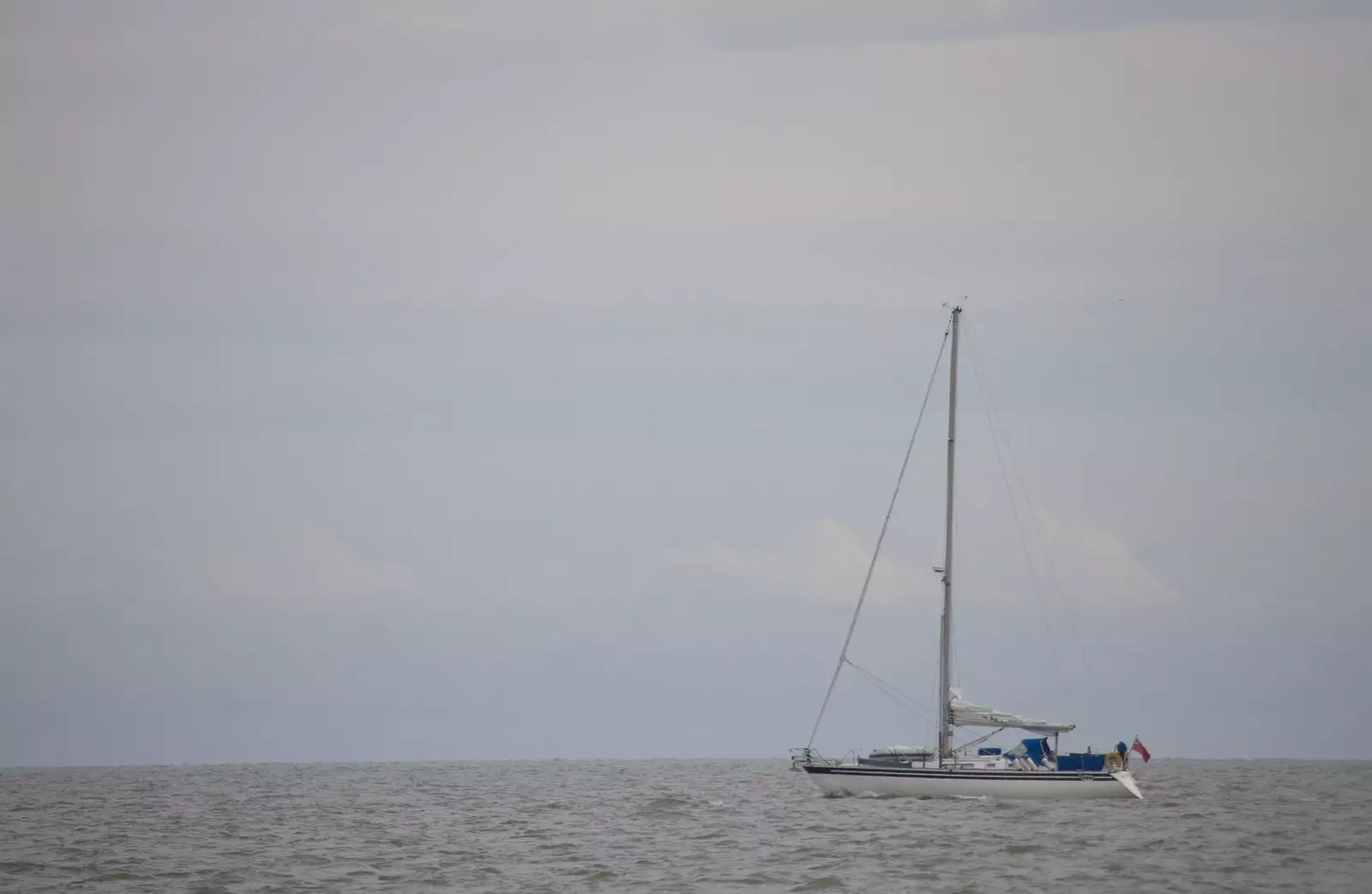 A yacht motors up the coast, from On The Beach Again, Southwold, Suffolk - 12th October 2014