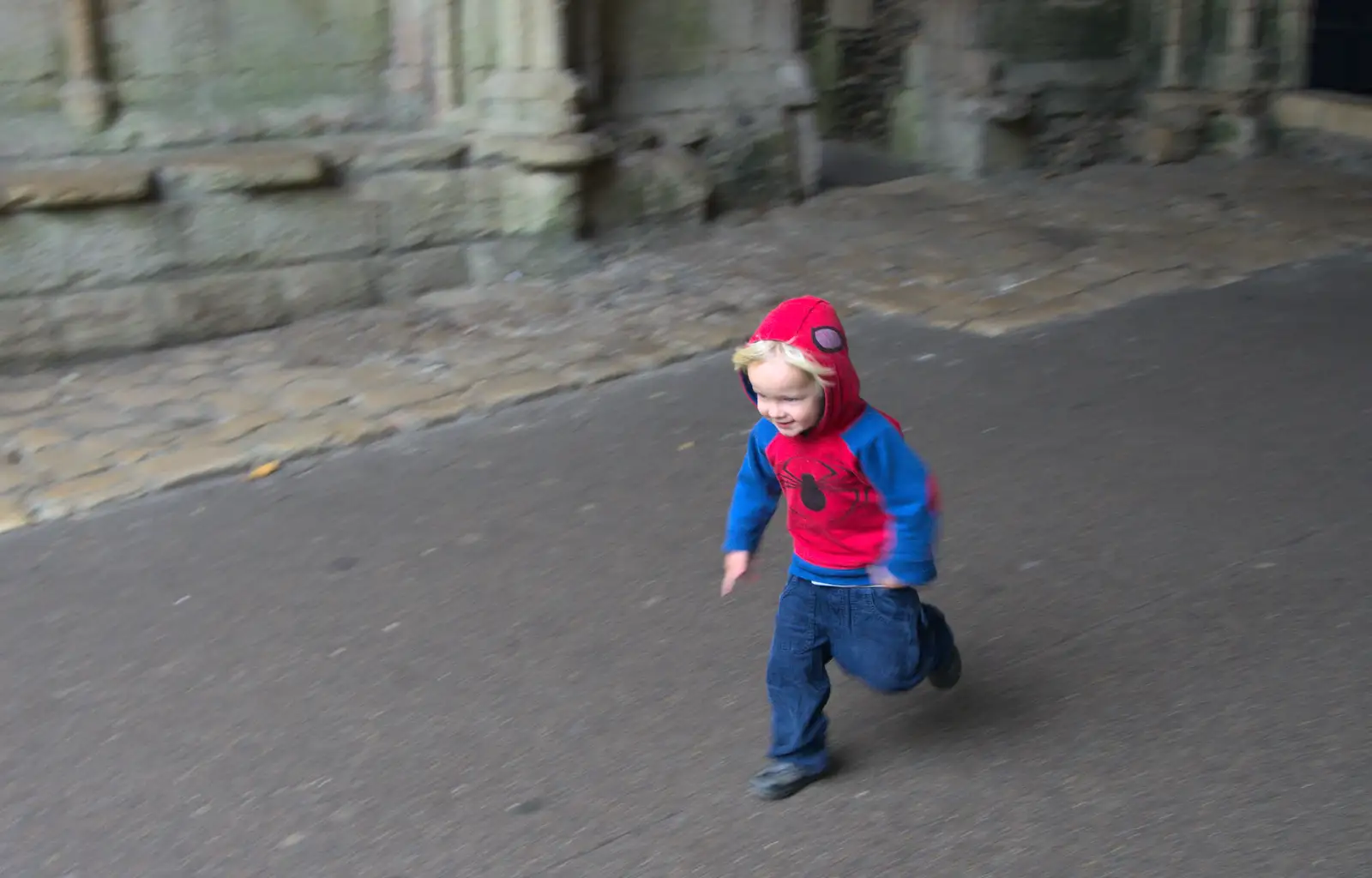 Harry runs through the Abbey Gate, from A Trip to Abbey Gardens, Bury St. Edmunds, Suffolk - 29th October 2014