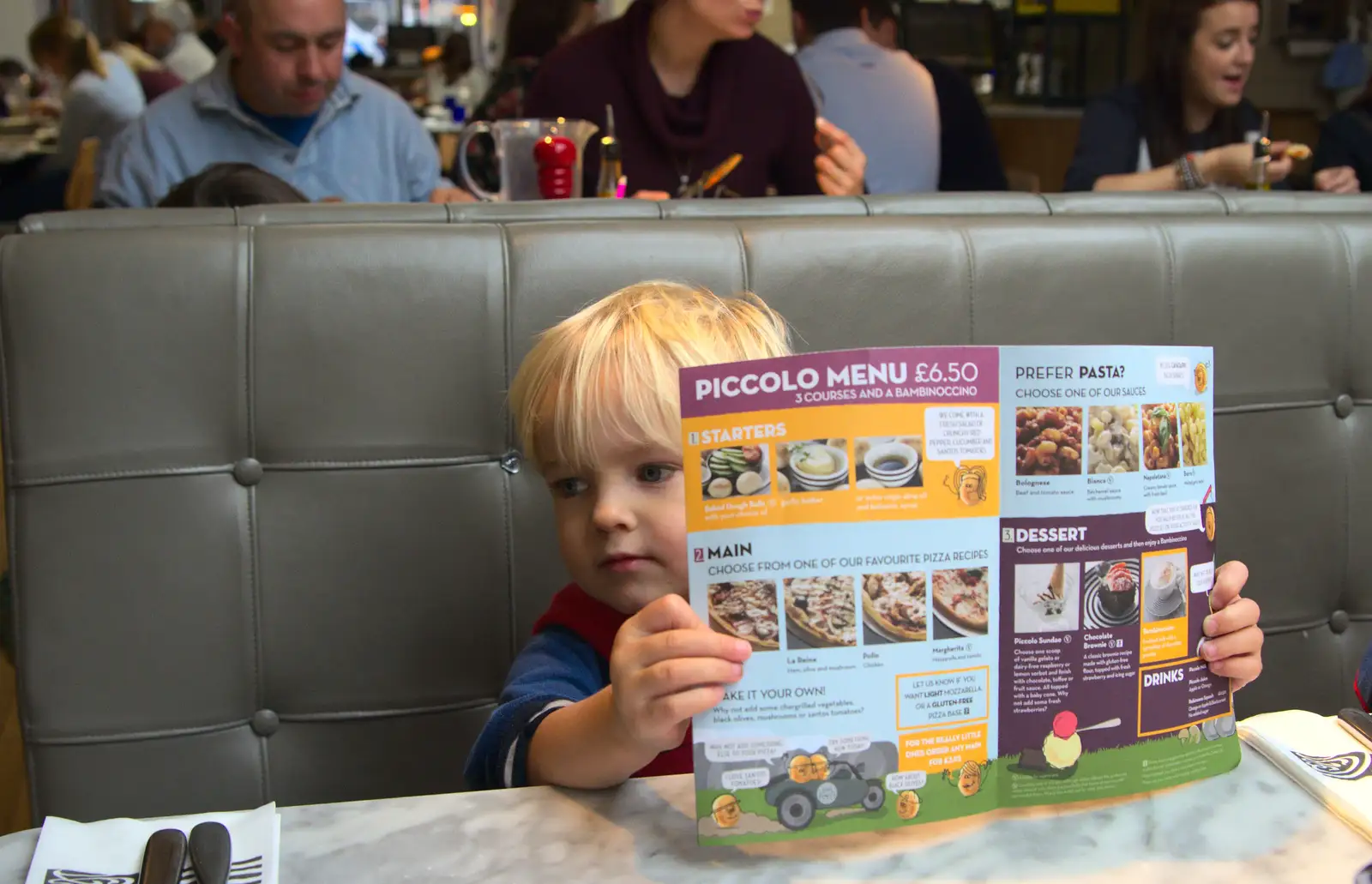 Harry checks out the menu in Pizza Express, from A Trip to Abbey Gardens, Bury St. Edmunds, Suffolk - 29th October 2014