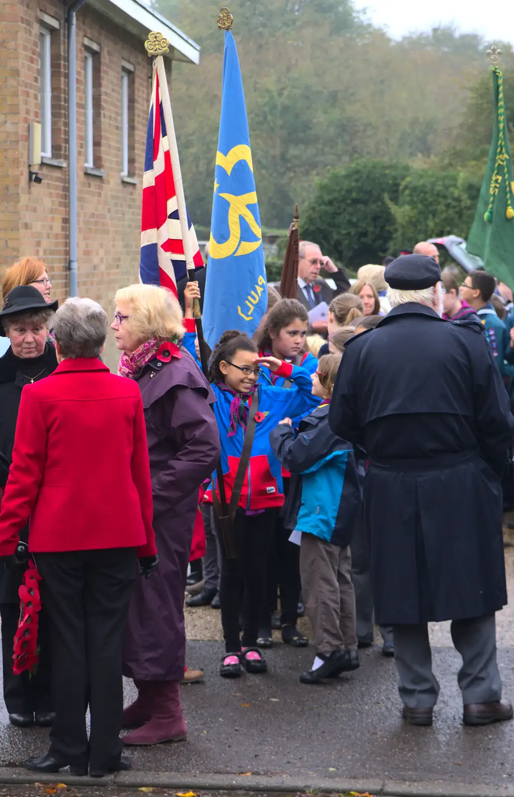 A flag-bearer gives a salute, from A Remembrance Sunday Parade, Eye, Suffolk - 9th November 2014