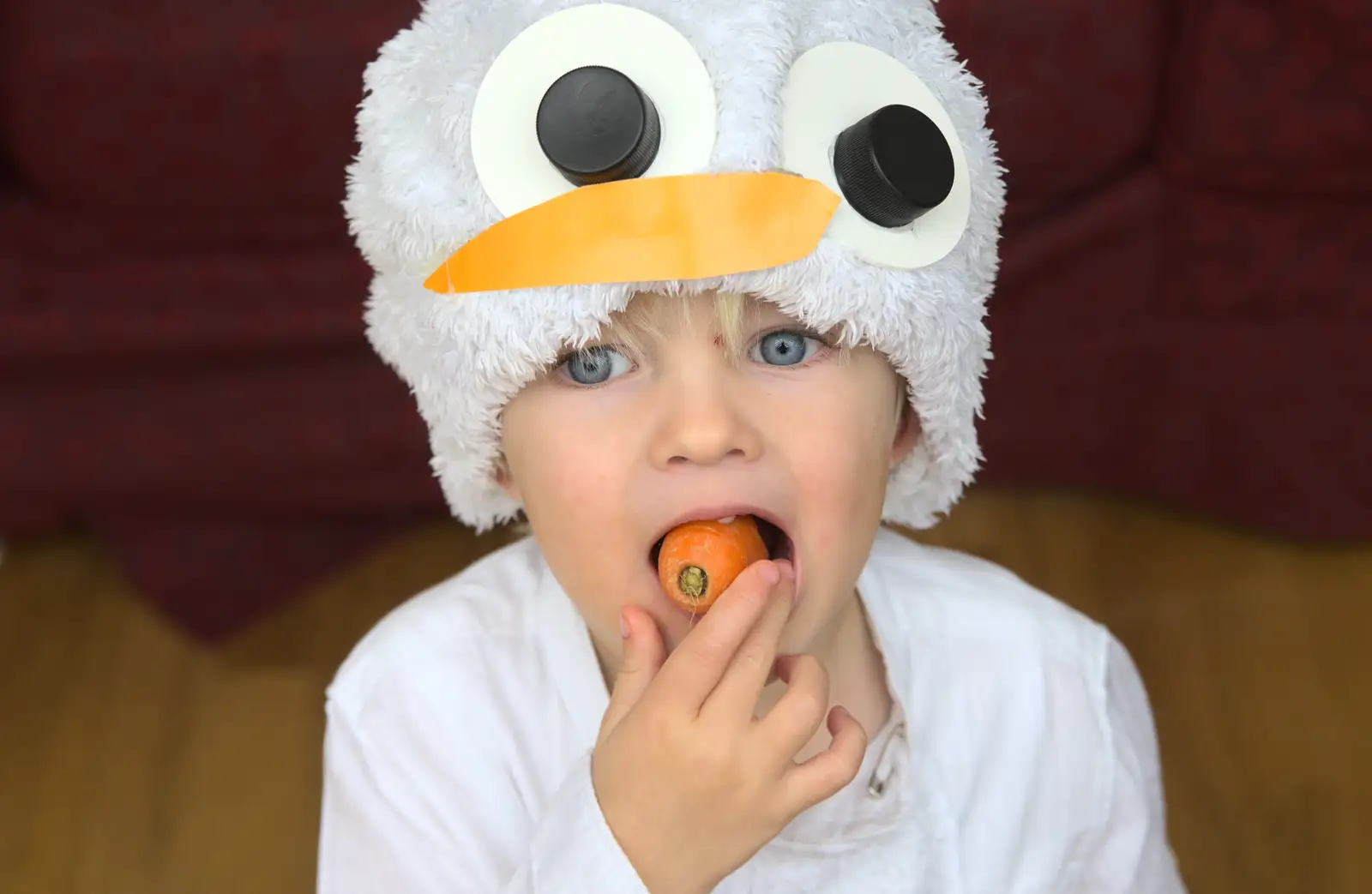 Harry eats the costume carrot, from November Singing, Gislingham Primary School, Suffolk - 17th November 2014