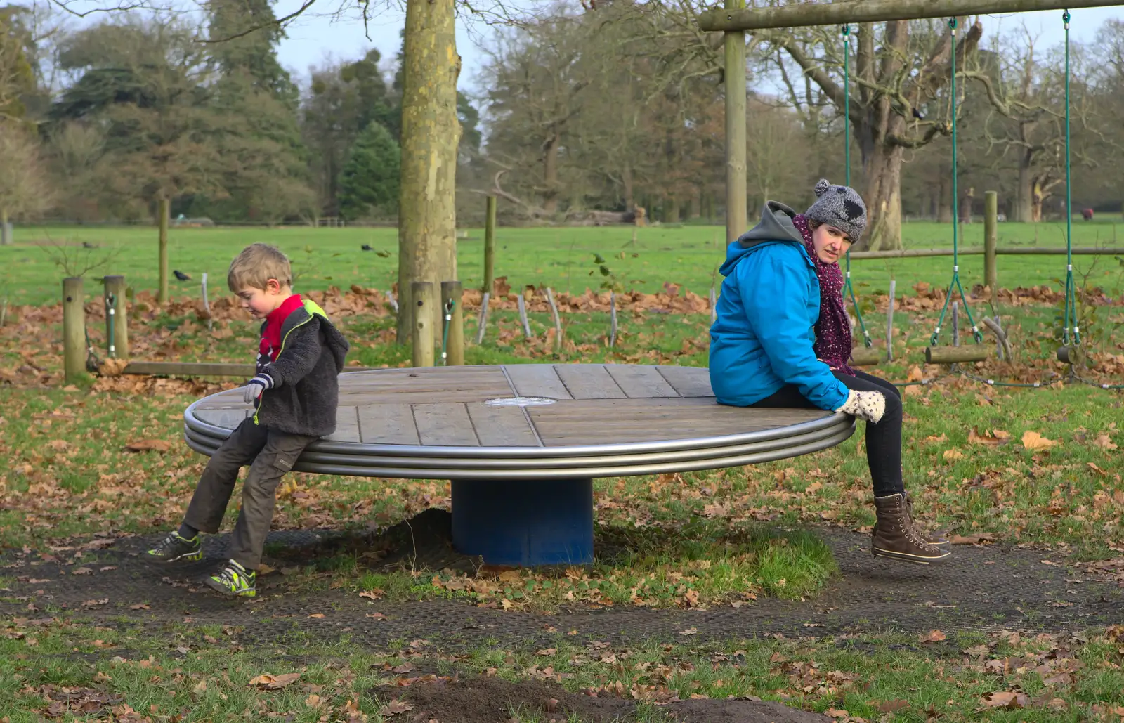 Fred and Isobel on the roundabout, from Cameraphone Randomness and a Thornham Walk, Suffolk - 14th December 2014