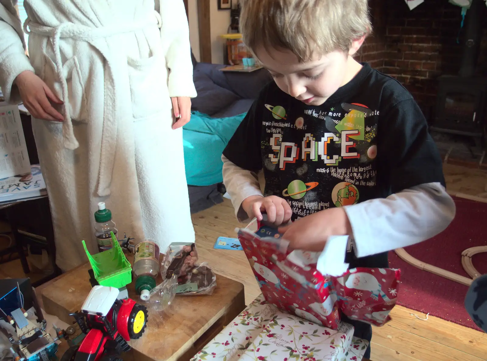 Fred tears into a present, from Christmas Day at the Swan Inn, Brome, Suffolk - 25th December 2014