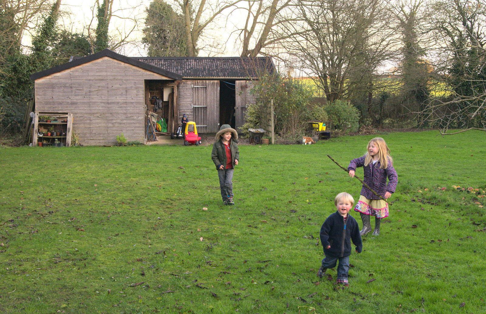 The children run around the garden with sticks from Christmas Day at the Swan Inn, Brome, Suffolk - 25th December 2014