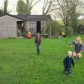 The children run around the garden with sticks, Christmas Day at the Swan Inn, Brome, Suffolk - 25th December 2014