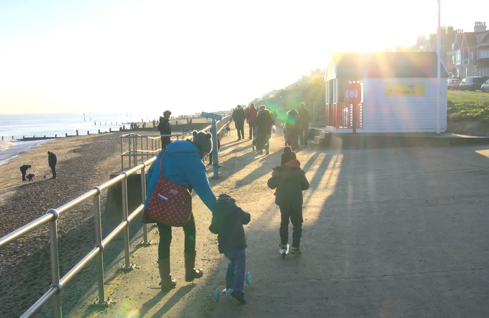 We head off down the promenade, from Sunset on the Beach, Southwold, Suffolk - 30th December 2014