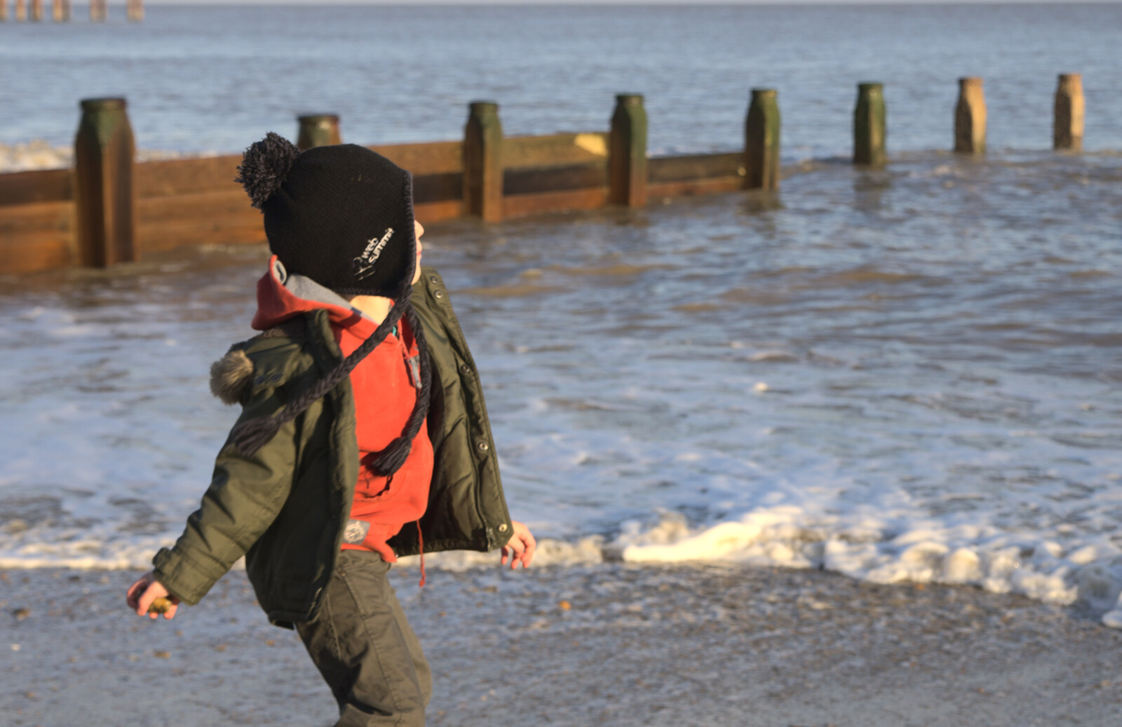 Fred hurls stones into the sea from Sunset on the Beach, Southwold, Suffolk - 30th December 2014