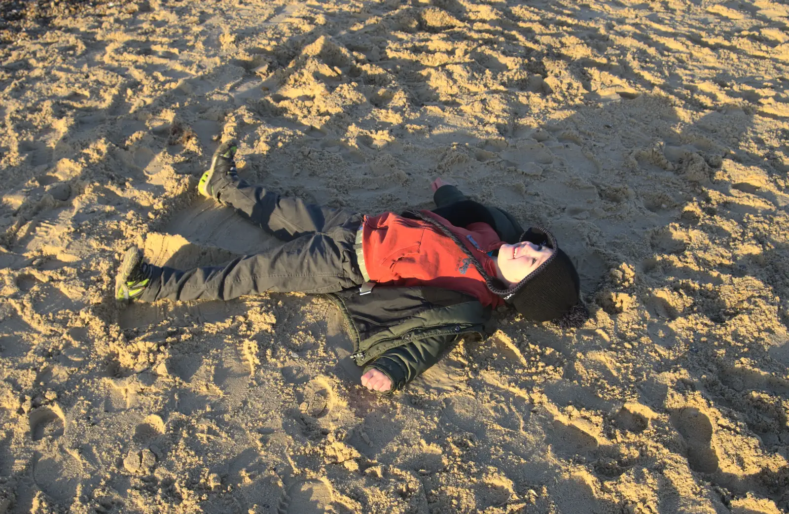 Fred does sand angels, from Sunset on the Beach, Southwold, Suffolk - 30th December 2014