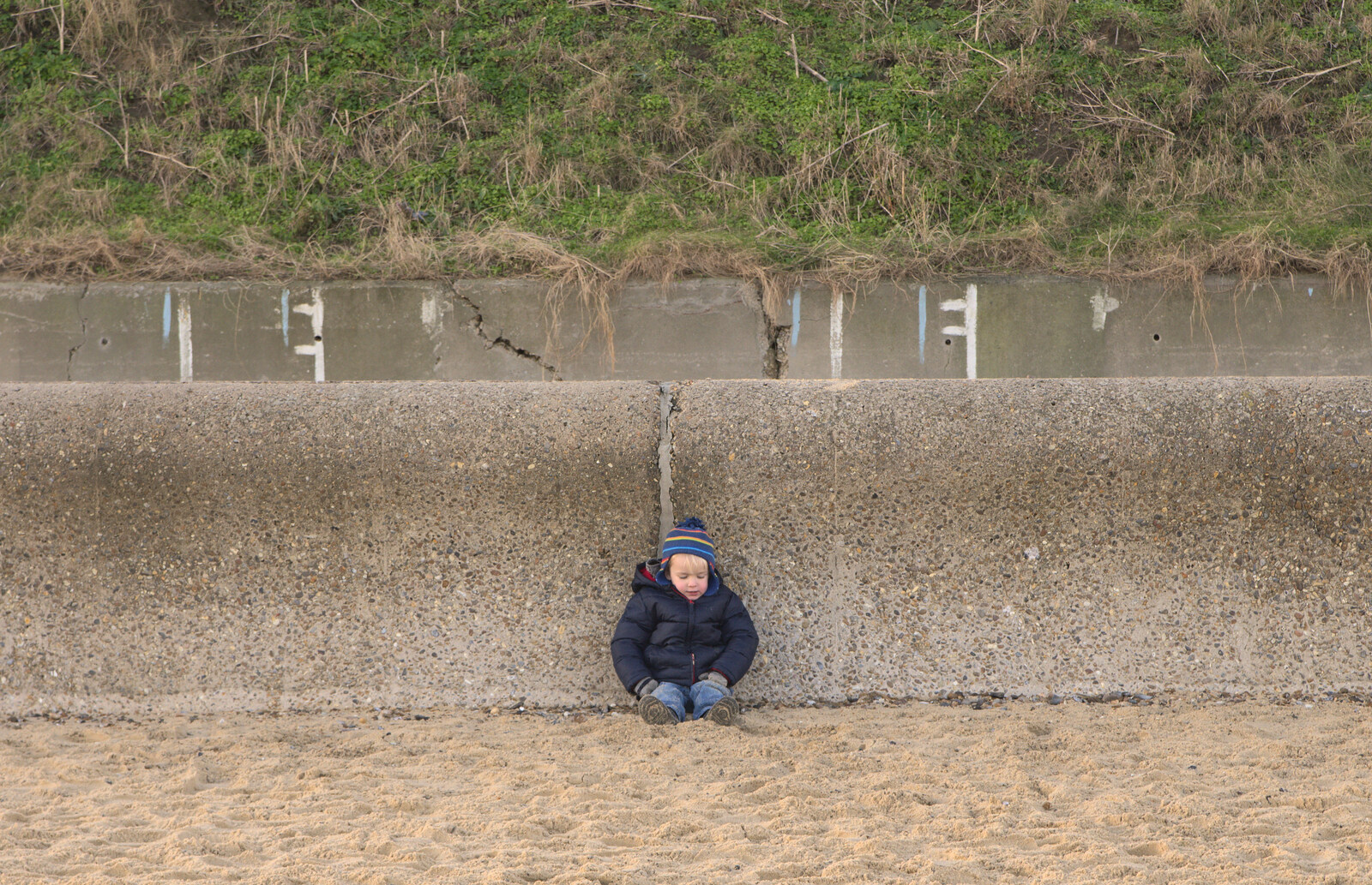Harry sits against the sea wall from Sunset on the Beach, Southwold, Suffolk - 30th December 2014