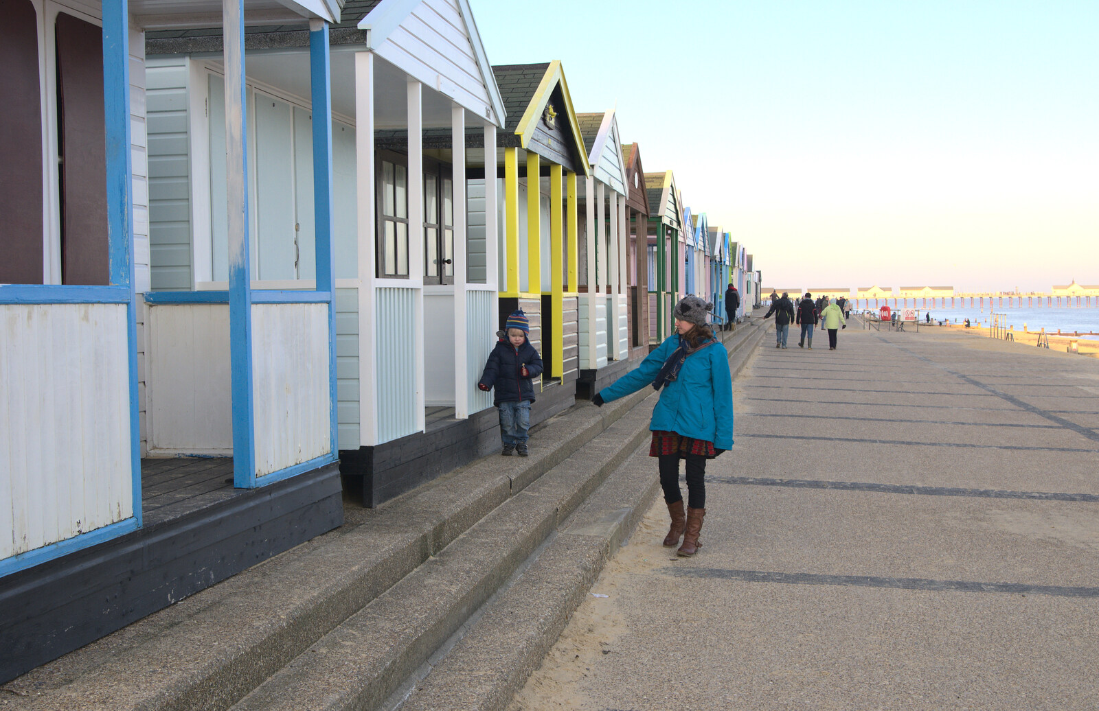 Harry walks along by the beach huts from Sunset on the Beach, Southwold, Suffolk - 30th December 2014