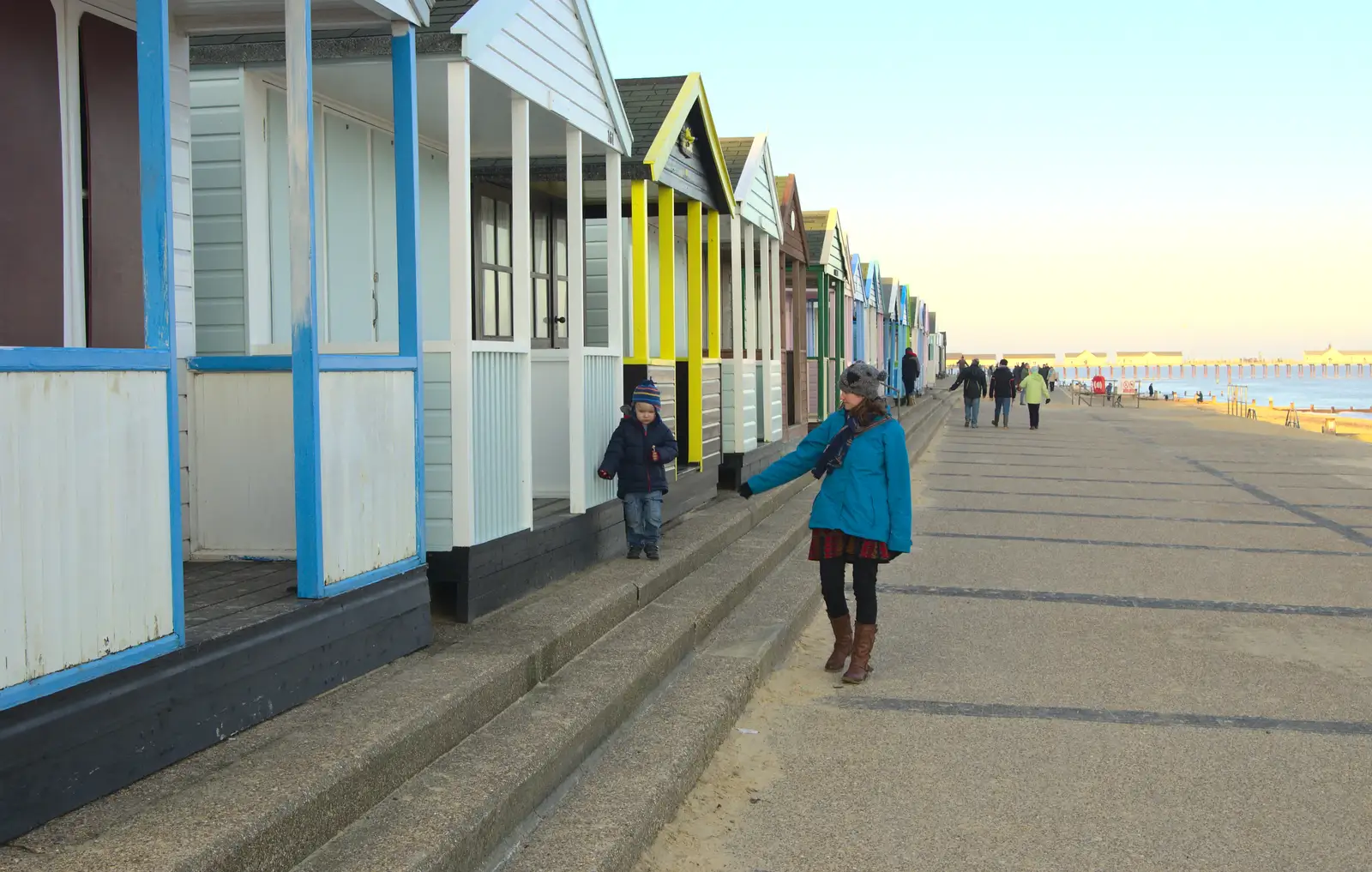 Harry walks along by the beach huts, from Sunset on the Beach, Southwold, Suffolk - 30th December 2014