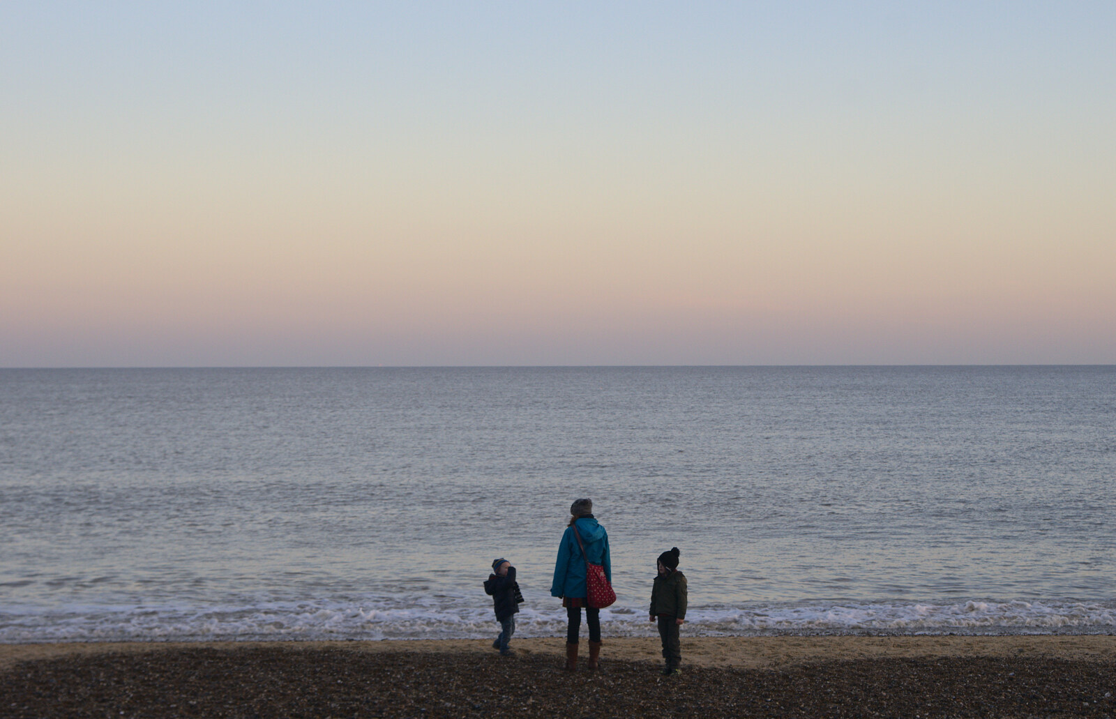 The gang stand by the sea's edge from Sunset on the Beach, Southwold, Suffolk - 30th December 2014