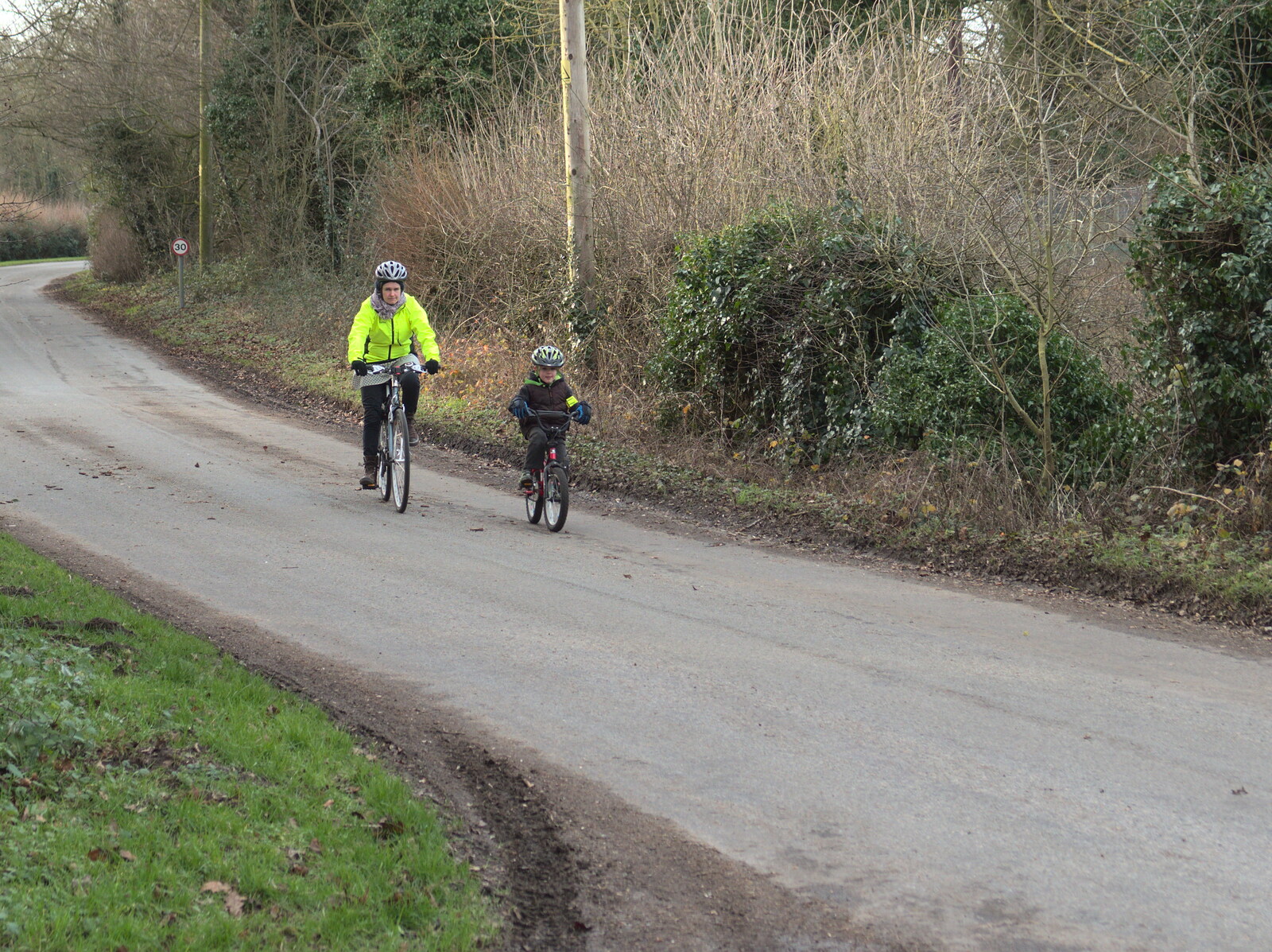 Isobel and Fred cycle down Brome Street from The BBs do a Recording, Hethel, Norfolk - 18th January 2015
