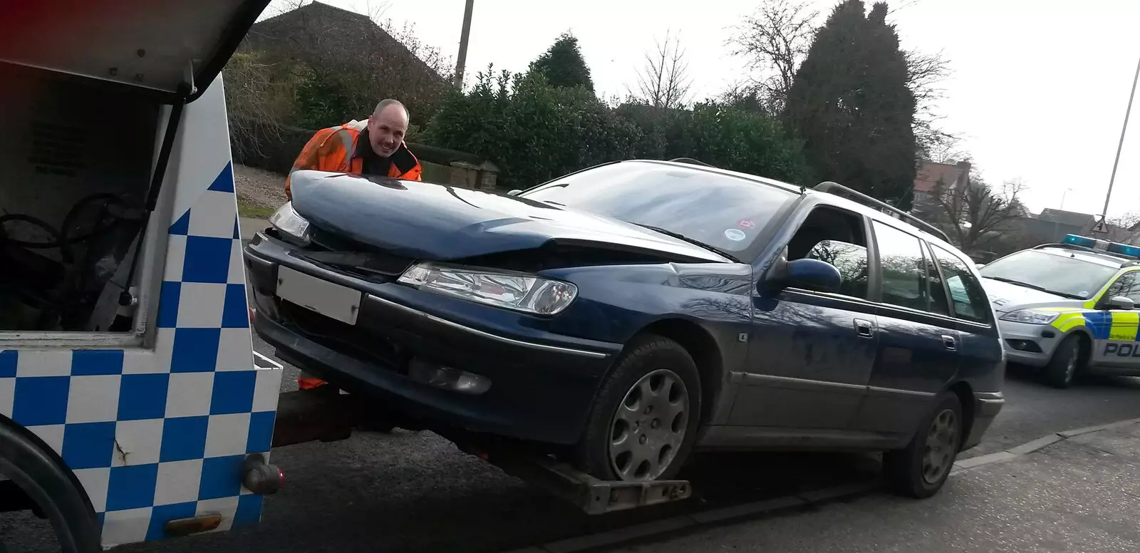 The car gets hitched up to a tow truck, from A Crashed Car and Greenhouse Demolition, Brome, Suffolk - 20th March 2015