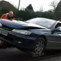 The car gets hitched up to a tow truck, A Crashed Car and Greenhouse Demolition, Brome, Suffolk - 20th March 2015