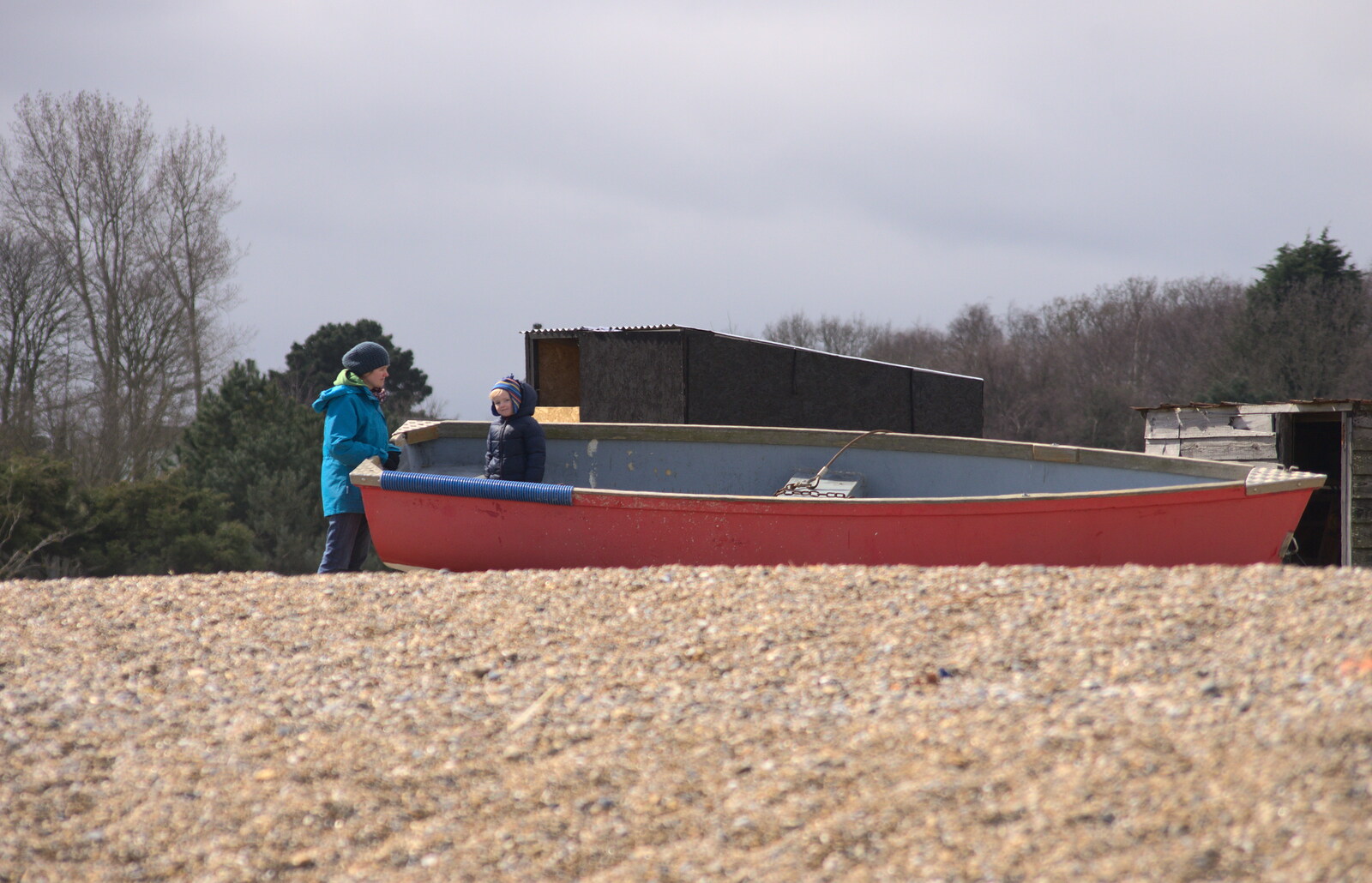 Harry messes about in a boat as Isobel looks on from A Day on the Beach, Dunwich, Suffolk - 6th April 2015