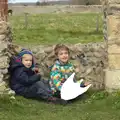 Harry and Fred hide from the wind, A Day on the Beach, Dunwich, Suffolk - 6th April 2015