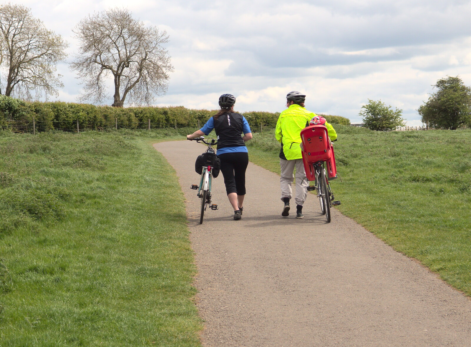Suey and Isobel push their bikes up a hill from The BSCC Weekend Away, Lyddington, Rutland - 9th May 2015