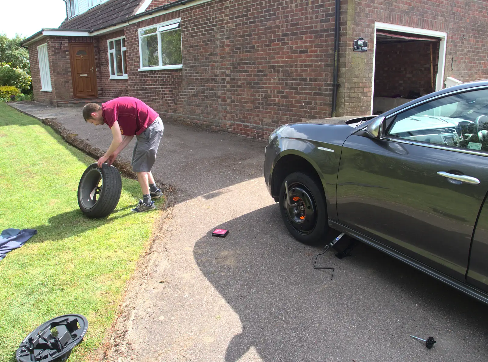 The Boy Phil is sorting out a flat tyre, from A Derelict Petrol Station, Palgrave, Suffolk - 16th May 2015