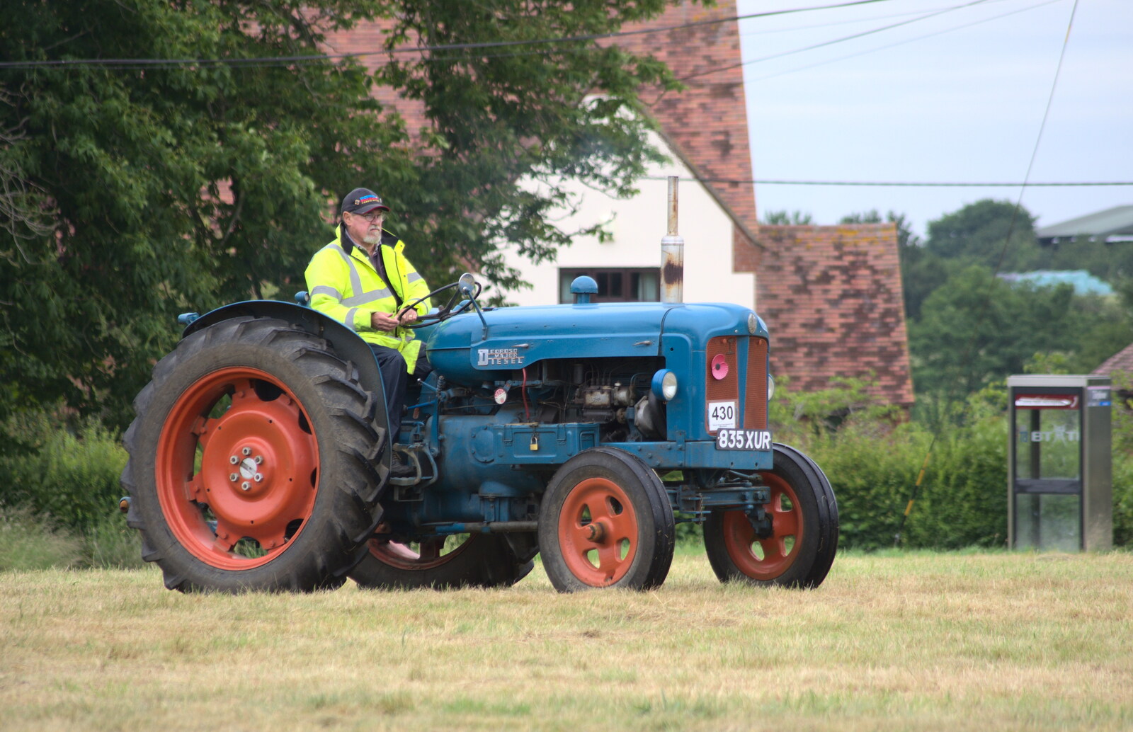 Another vintage tractor drives onto the green from Thrandeston Pig Roast, Thrandeston Little Green, Suffolk - 28th June 2015