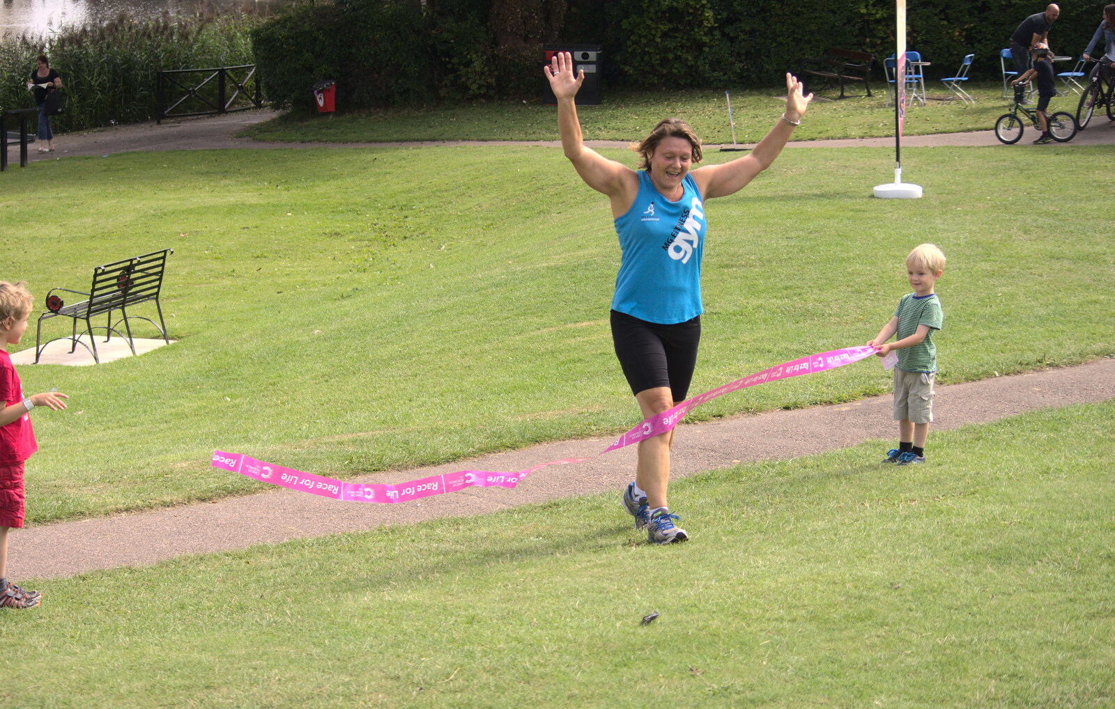 Harry holds on to the finishing tape from A Race For Life, The Park, Diss, Norfolk - 16th August 2015