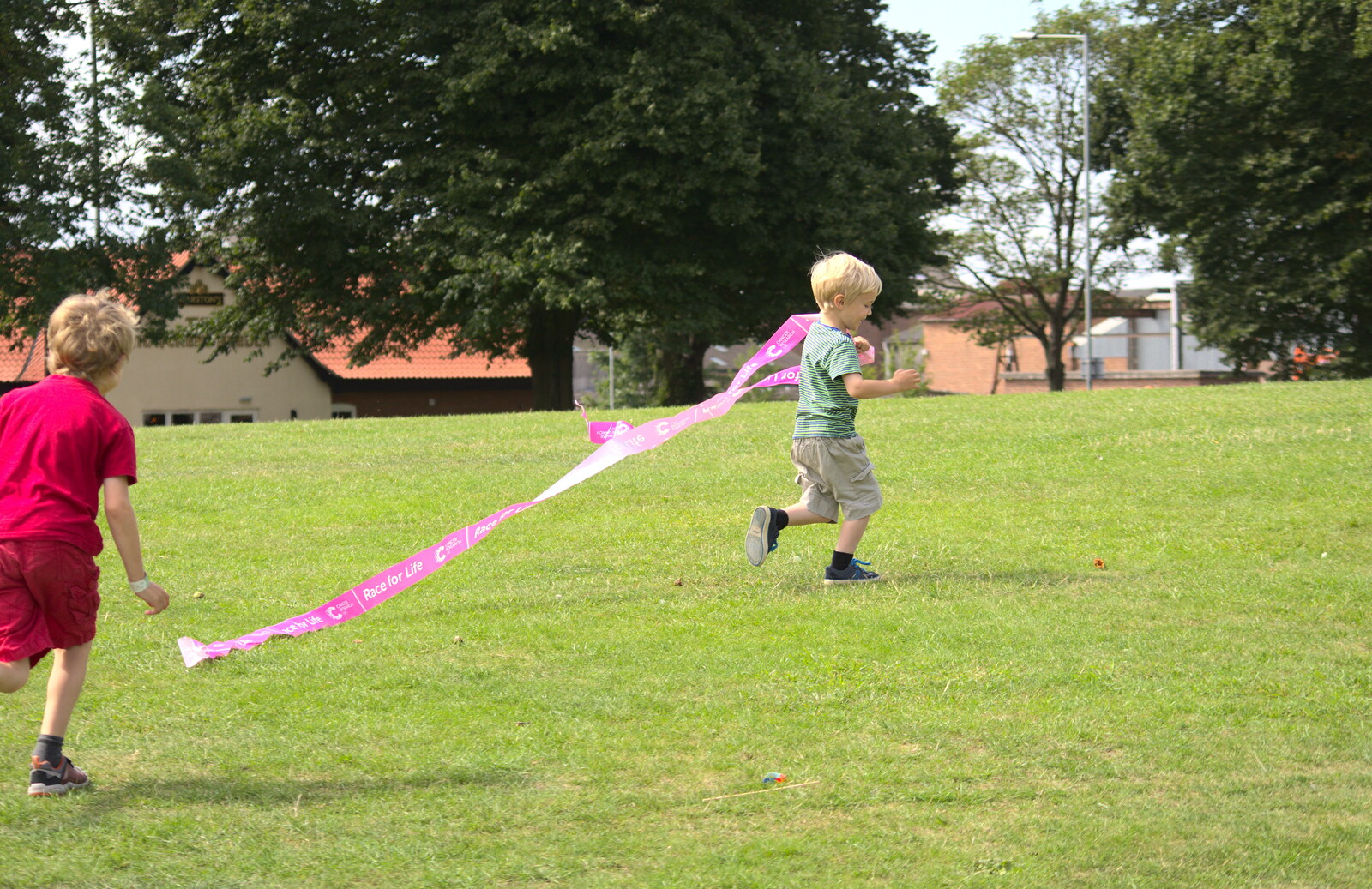 Harry runs off with the tape from A Race For Life, The Park, Diss, Norfolk - 16th August 2015