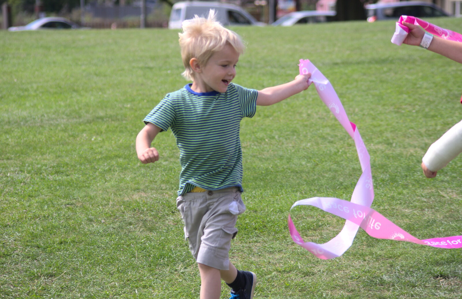 Harry runs around with the finishing tape from A Race For Life, The Park, Diss, Norfolk - 16th August 2015