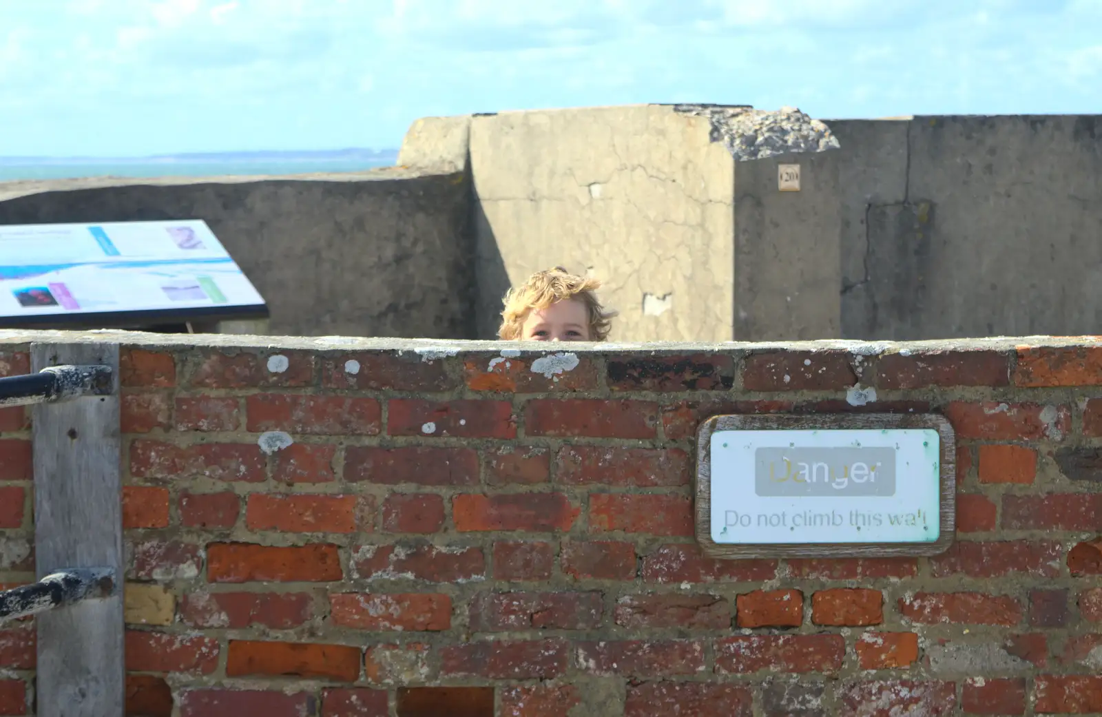 Fred peeps out from behind a wall, from A Trip to Hurst Castle, Keyhaven, Hampshire - 28th August 2015