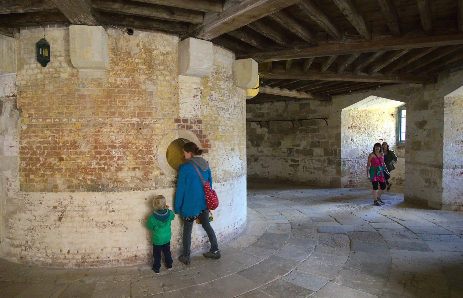 Isobel looks through a hole in the wall, from A Trip to Hurst Castle, Keyhaven, Hampshire - 28th August 2015