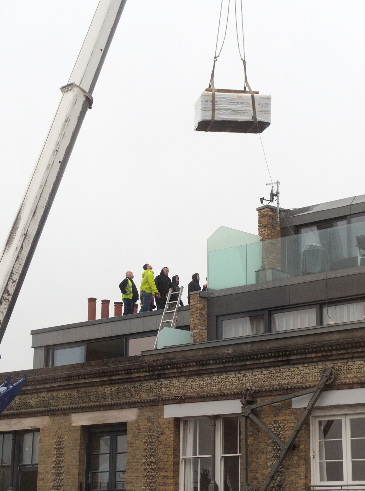 The tub is lowered into position from Hot-tub Penthouse, Thornham Walks, and Building, London and Suffolk - 12th November 2015