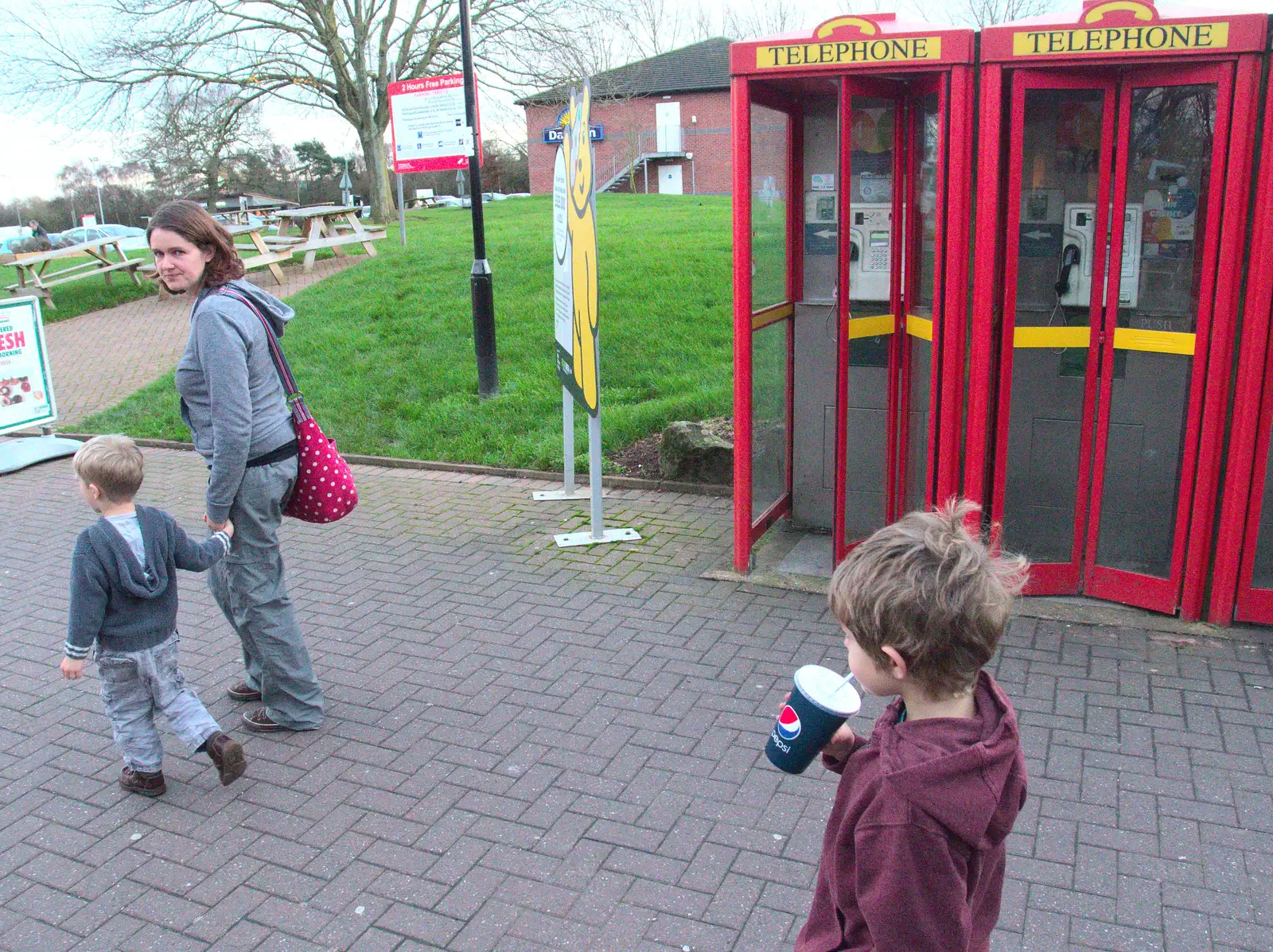 Isobel looks over by some non-standard phone boxes, from A Party and a Road Trip to Chester, Suffolk and Cheshire - 20th December 2015