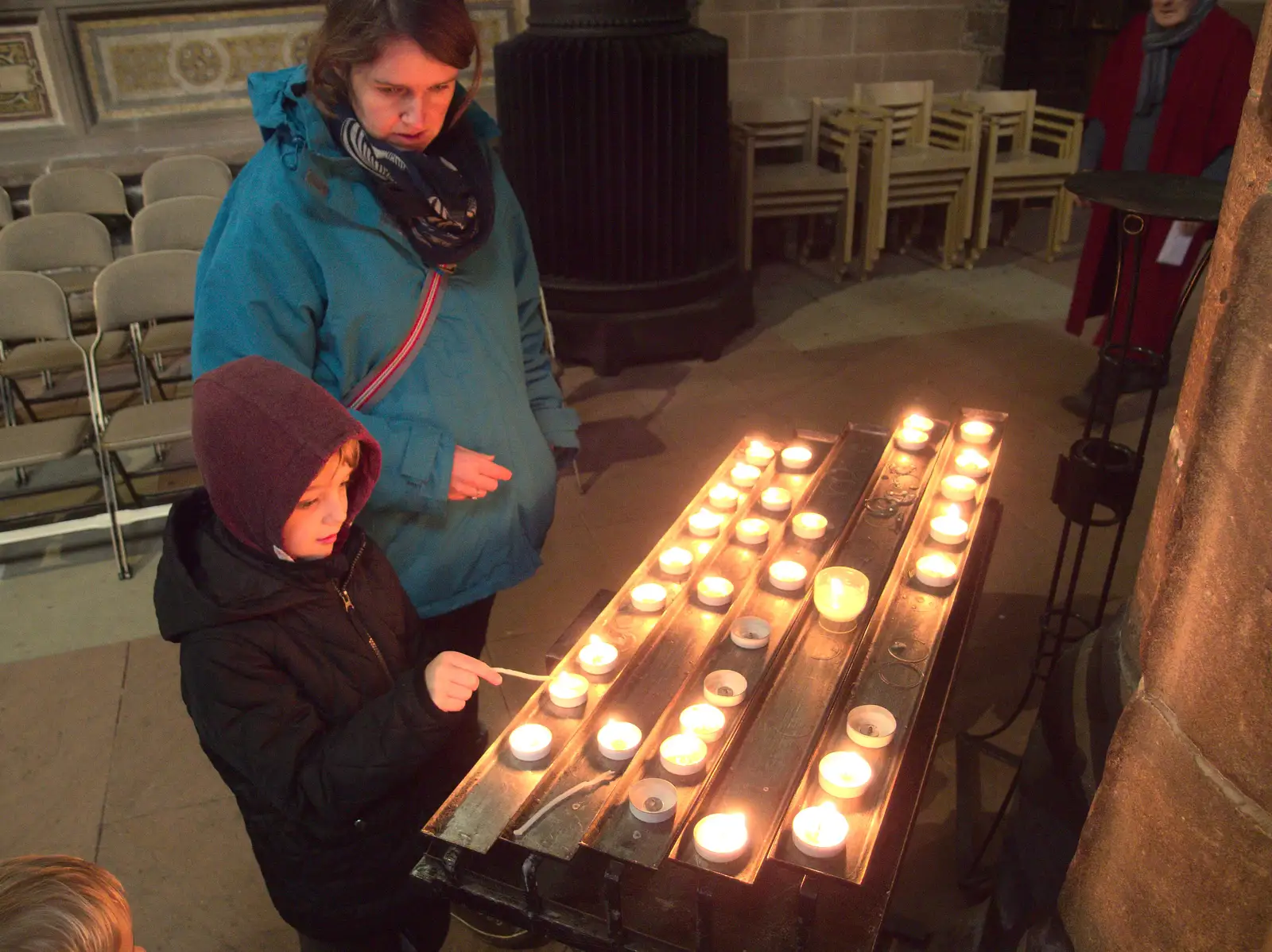 Fred lights a votive candle, from A Party and a Road Trip to Chester, Suffolk and Cheshire - 20th December 2015