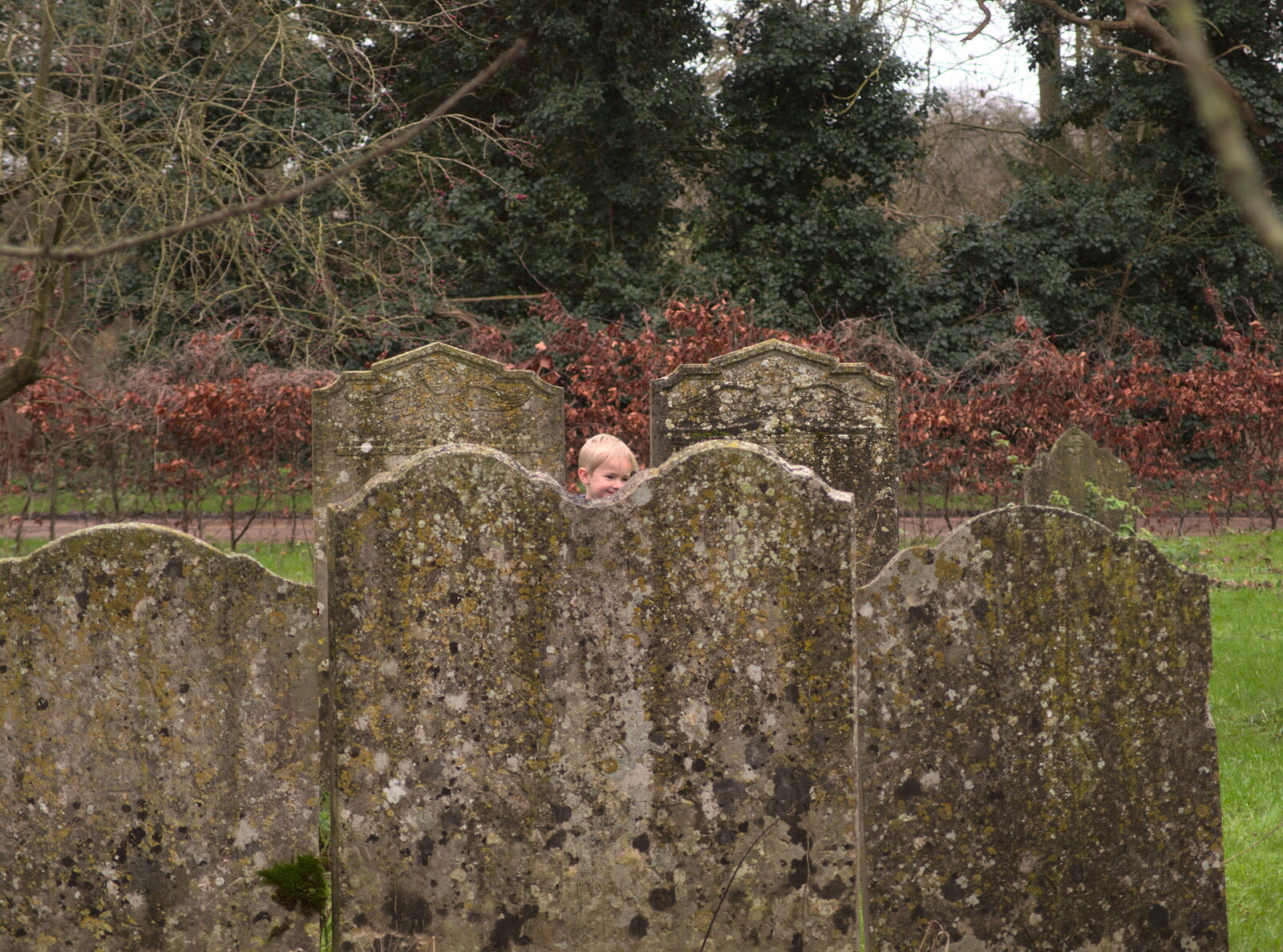 Harry peeks up from behind the gravestones from New Year's Eve With The BBs, The Barrel, Banham, Norfolk - 31st December 2015