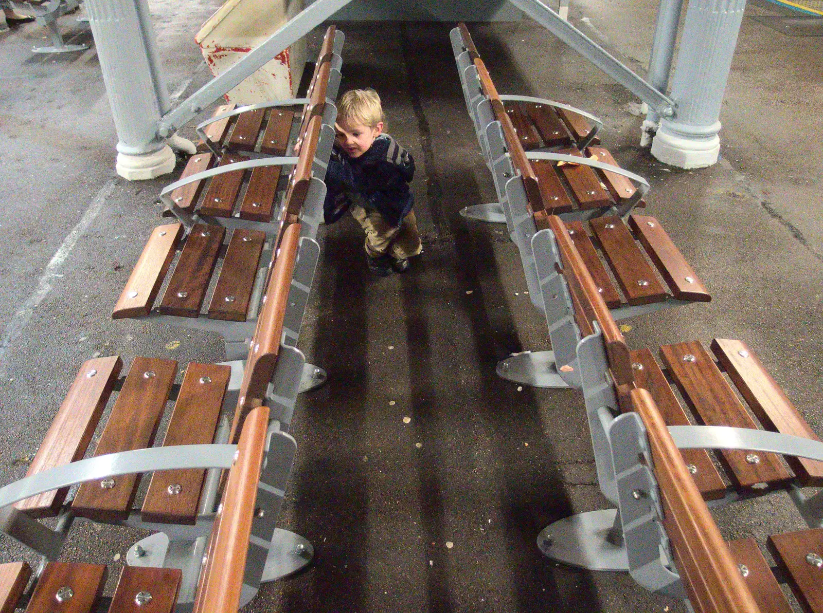 Harry hides behind some platform seats, from Isobel Goes to Lyon, Ipswich Station, Burrell Road - 24th January 2016