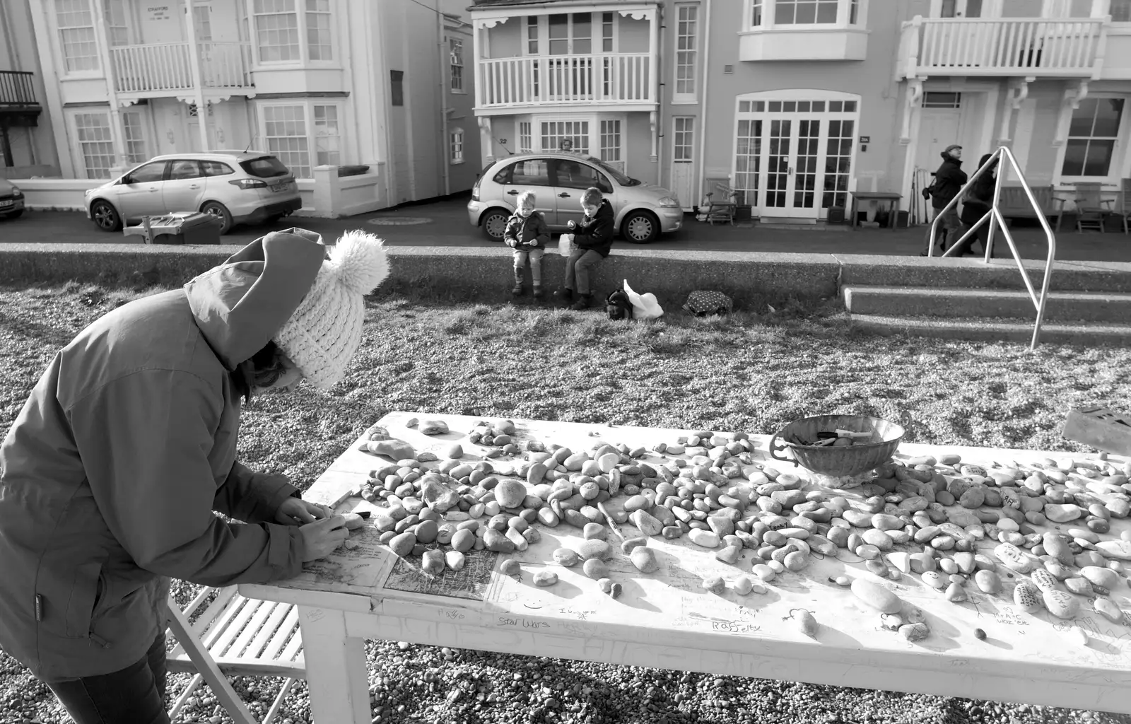 Isobel writes on a pebble, from A Trip to Aldeburgh, Suffolk - 7th February 2016