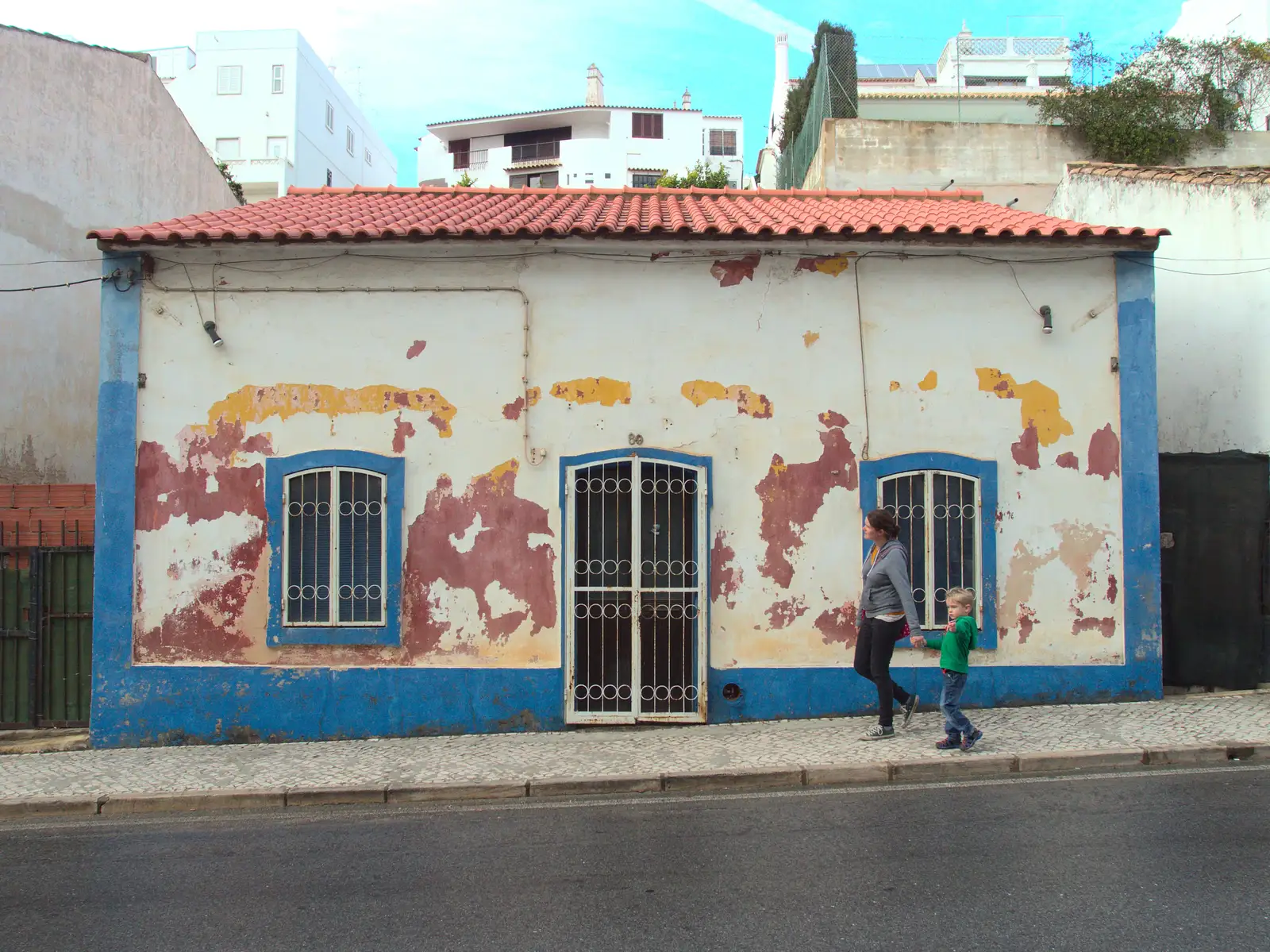 Isobel and Harry pass a quaintly-fading building, from A Trip to Albufeira: The Hotel Paraiso, Portugal - 3rd April 2016