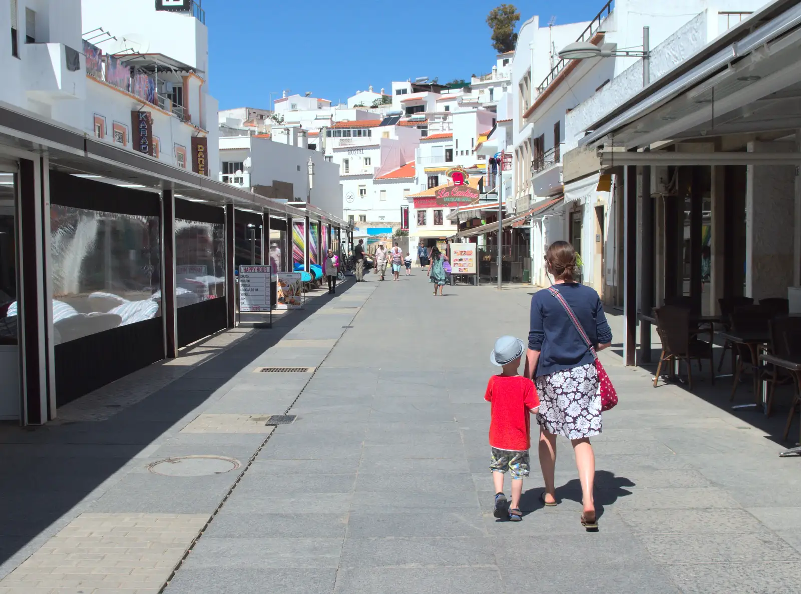 Harry and Isobel wander past the bar strip, from Gary and Vanessa's Barbeque, Alcantarilha, Algarve, Portugal - 7th April 2016