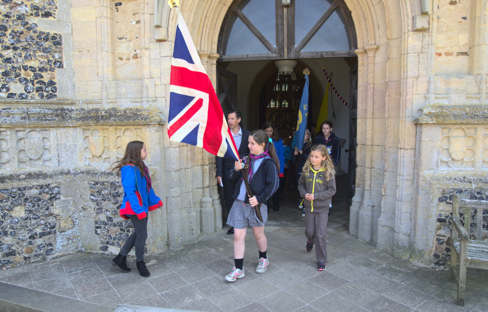 The flag bearer comes out of the church from A Trip to the Office and the Mayor-Making Parade, Eye, Suffolk - 4th June 2016