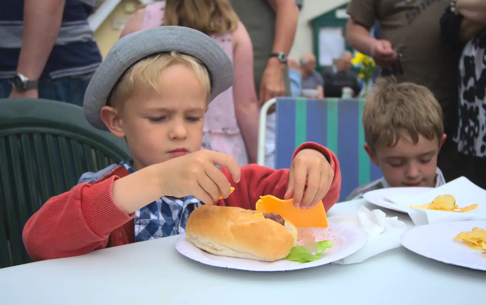 Harry eyes his 'cheese food slice' suspiciously, from The Queen's Village Hall Birthday, Brome, Suffolk - 12th June 2016