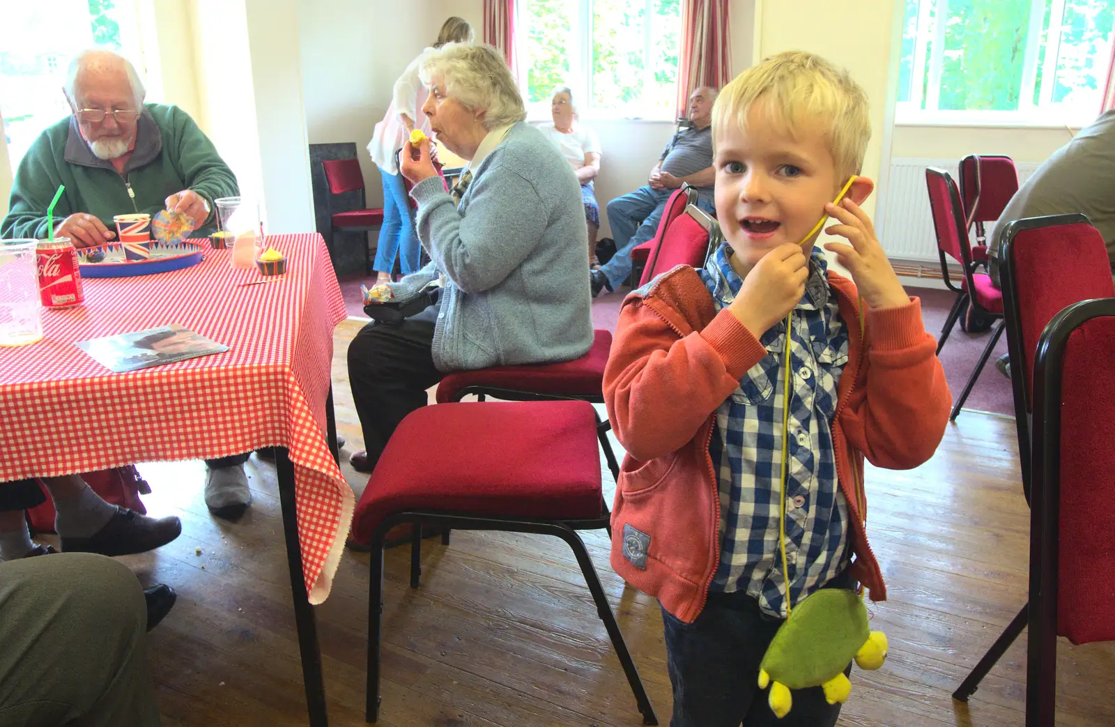 Harry hangs his purse from his ear for some reason, from The Queen's Village Hall Birthday, Brome, Suffolk - 12th June 2016