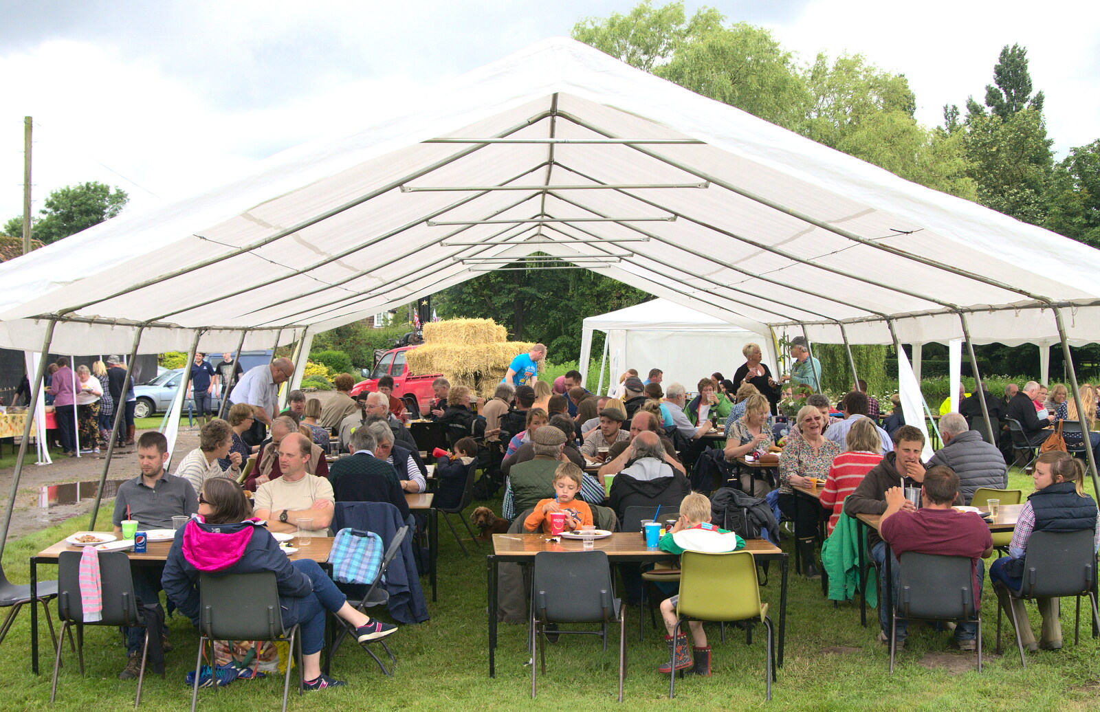 The crowd huddles under the marquee from Thrandeston Pig, Little Green, Thrandeston, Suffolk - 26th June 2016