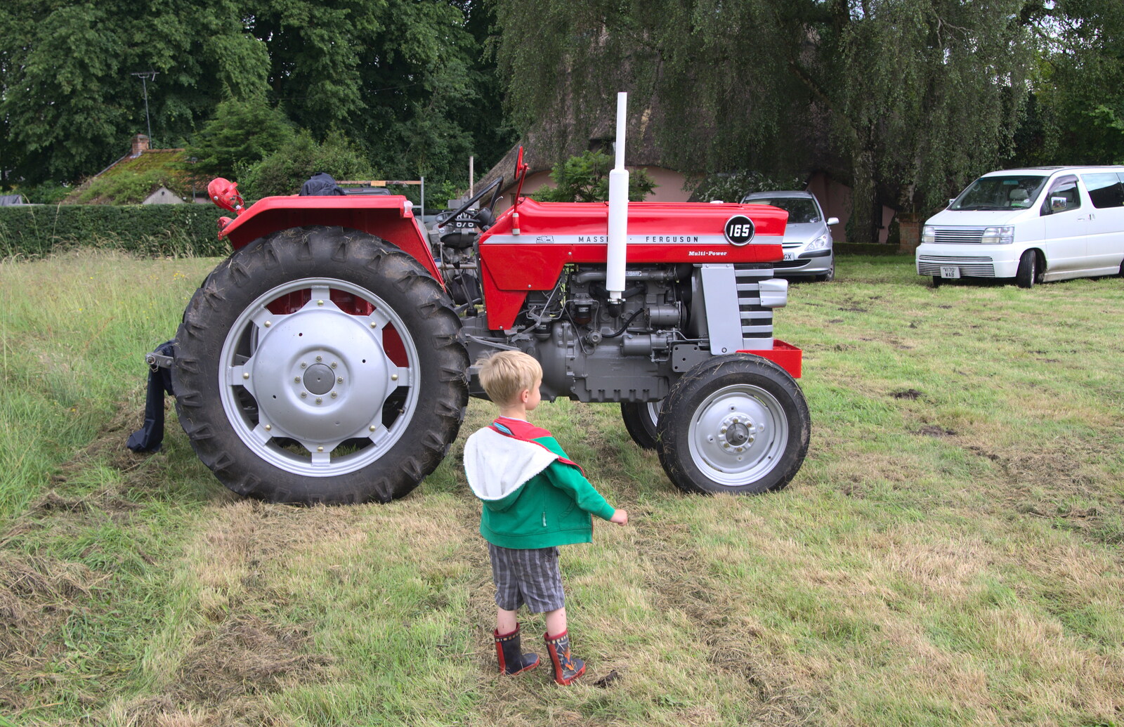 Harry wanders off to look at tractors from Thrandeston Pig, Little Green, Thrandeston, Suffolk - 26th June 2016