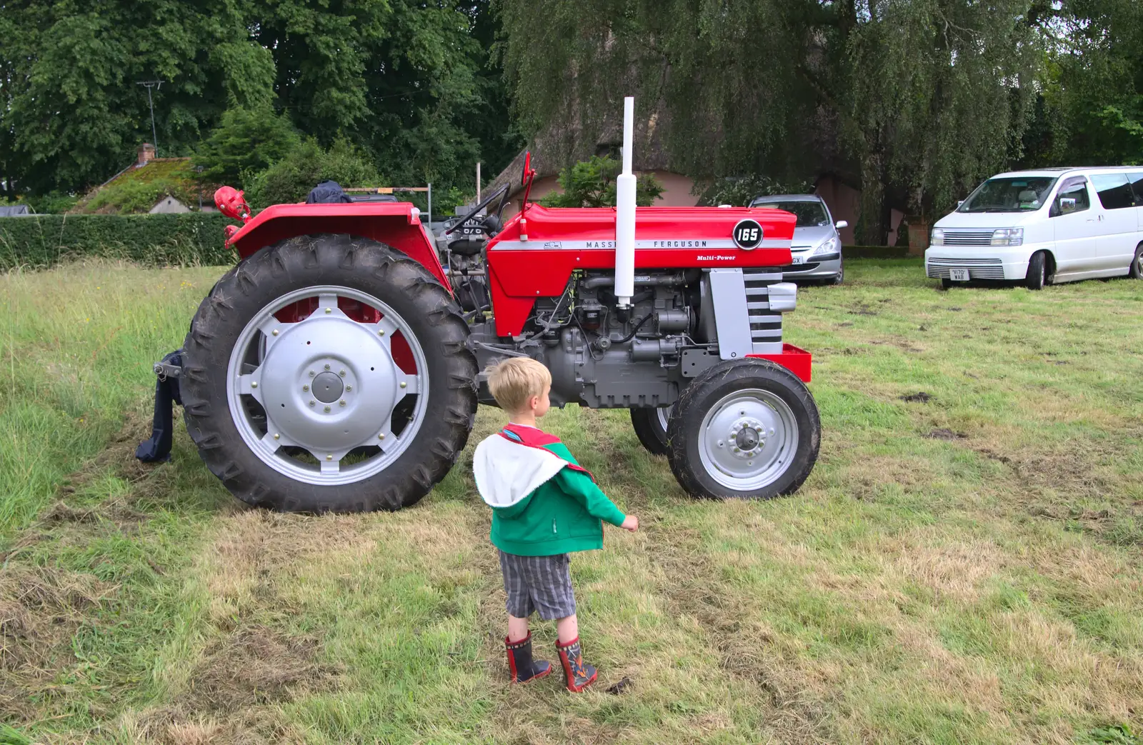 Harry wanders off to look at tractors, from Thrandeston Pig, Little Green, Thrandeston, Suffolk - 26th June 2016