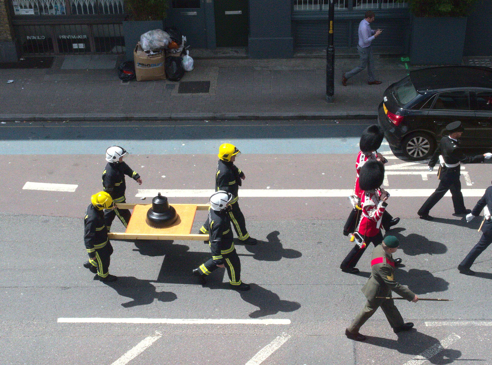 The firemen carry a bell from Harry's Sports Day and a London March, Southwark and Eye, Suffolk - 7th July 2016