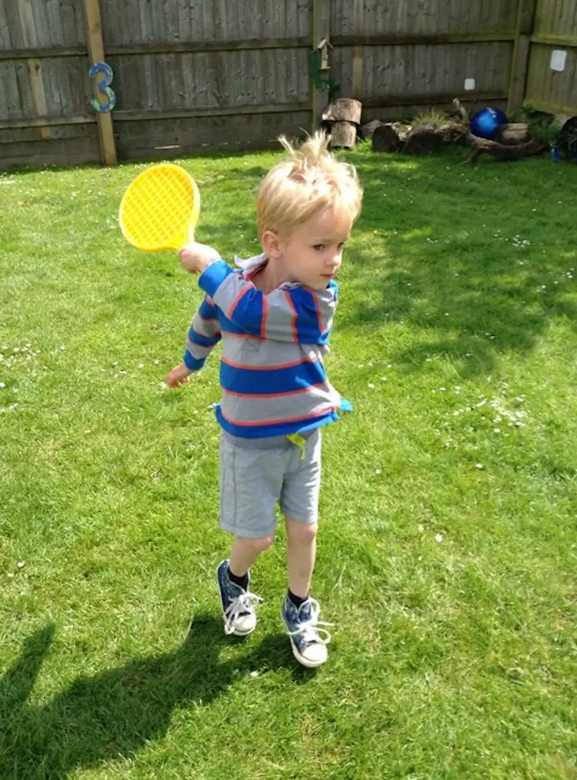 Harry has a swing with a small tennis racquet, from Harry's Nursery Life, Mulberry Bush, Eye, Suffolk - 8th July 2016