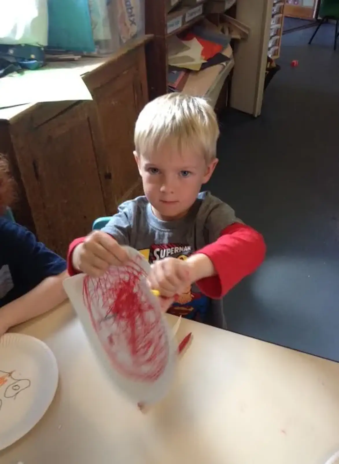 Harry draws on a paper plate, from Harry's Nursery Life, Mulberry Bush, Eye, Suffolk - 8th July 2016